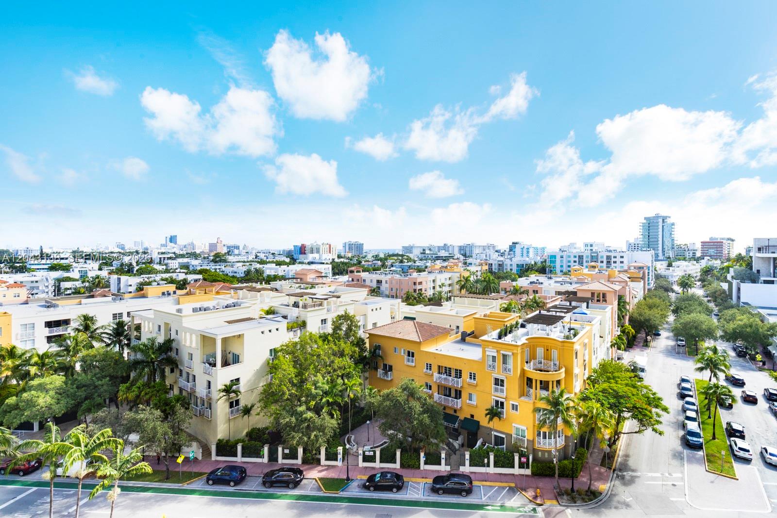 An elevated view shows a yellow apartment building surrounded by trees and city streets — 90 Alton Rd # 1005, Miami Beach FL 33139, MIAMI BEACH, FL