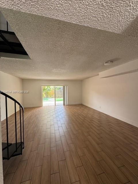 A rectangular swimming pool sits in front of a two-story building with palm trees — 6631 SW 41st Pl # 43, Davie FL 33314, DAVIE, FL
