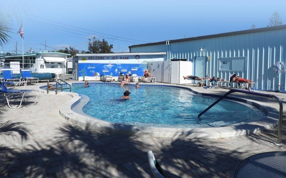 An outdoor swimming pool with lounge chairs and a mural-painted wall at a park — 138 PENNSYLVANIA STREET, PALMETTO, FL