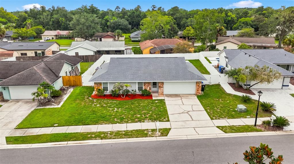 An aerial view of a single-story suburban house with a gray roof and driveway — 1003 WHEELER PLACE, OVIEDO, FL