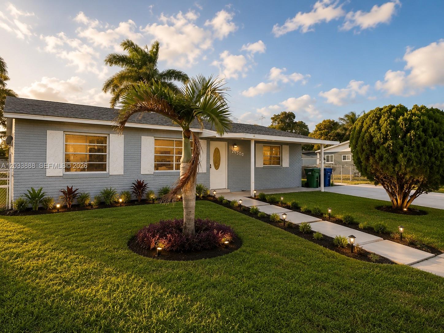 A single-story gray brick house with a palm tree and a paved walkway in front — 20500 NW 28th Ave # A, Miami Gardens FL 33056, MIAMI GARDENS, FL