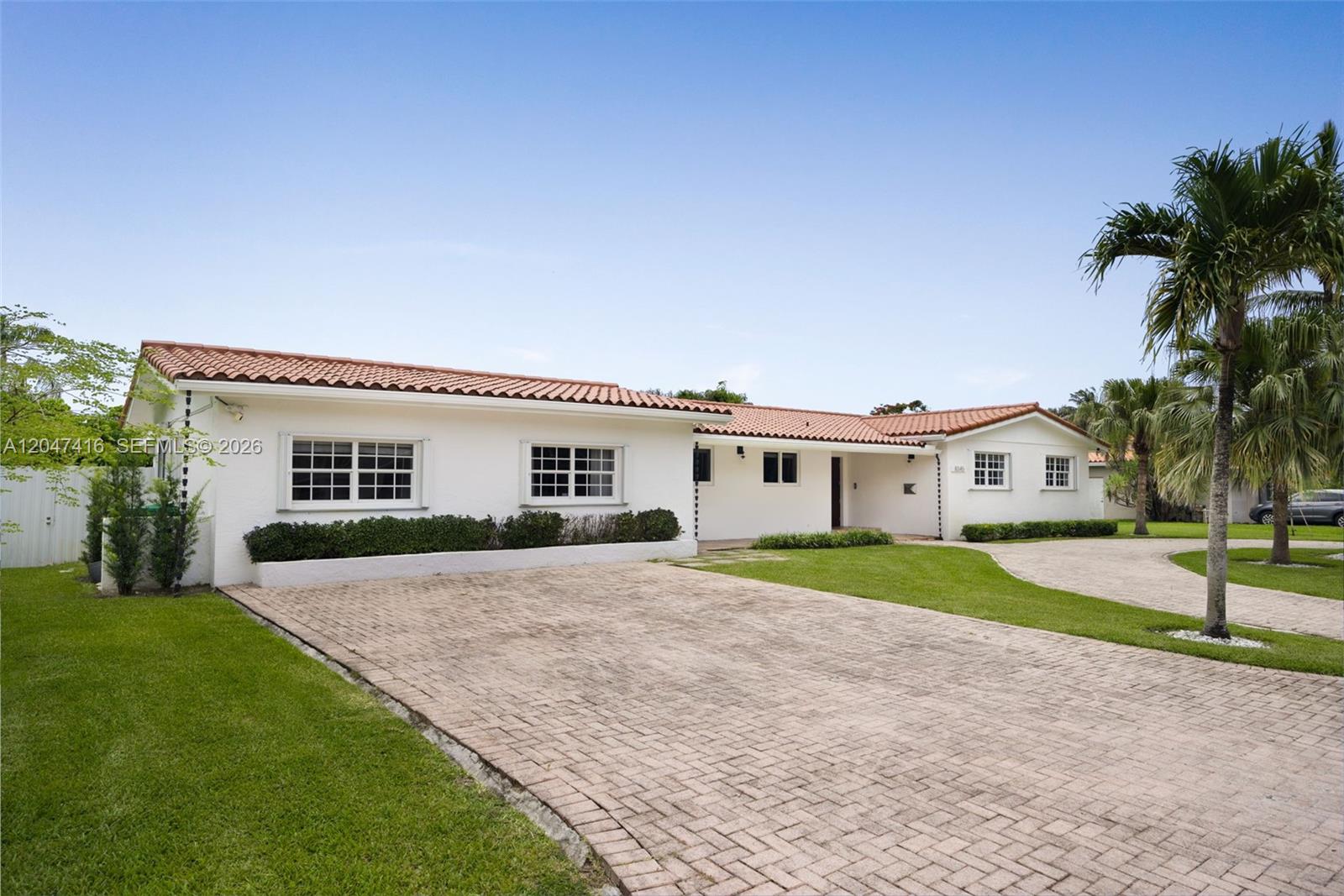 A white single-story house with a terracotta tile roof and a brick paver driveway — 8345 SW 90th St, Miami FL 33156, MIAMI, FL