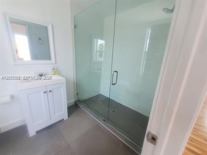 A bathroom featuring a white vanity, a mirror, and a glass-enclosed walk-in shower — 101 SE 2nd St # 2, Dania Beach FL 33004, DANIA BEACH, FL