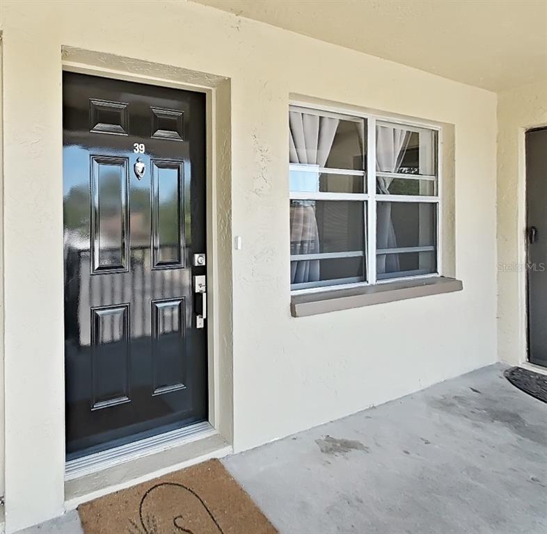 A black front door with the number 39 and a window with curtains — 2501 HARN BOULEVARD UNIT H39, CLEARWATER, FL