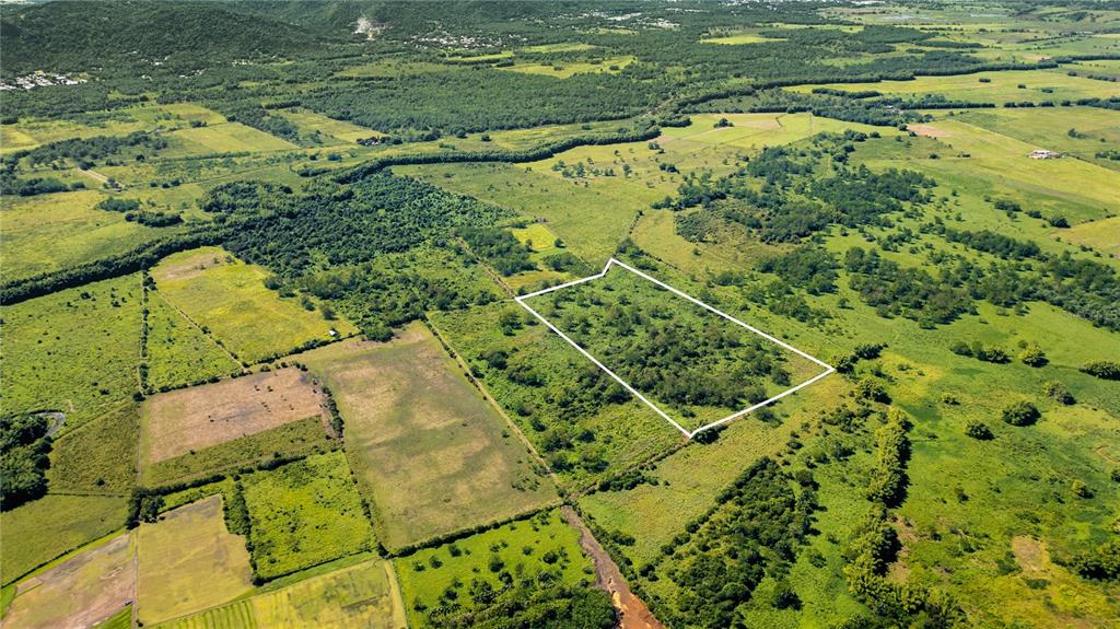 An aerial view shows a rectangular plot of land outlined in white amidst rural fields — 2 KM 162 BENAVENTE ROAD UNIT 725, HORMIGUEROS, PR