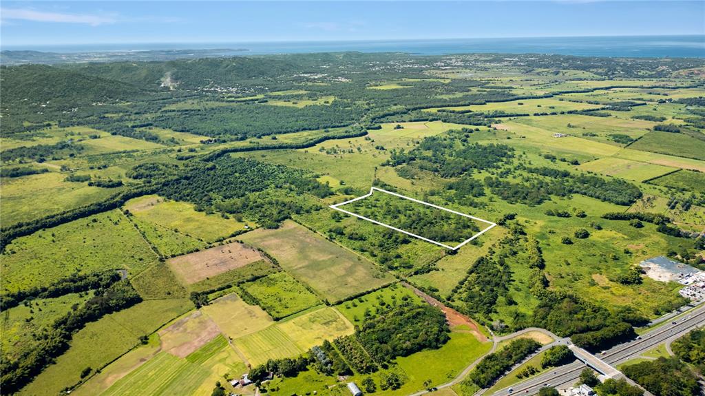 An aerial view shows a rectangular plot of land outlined in white amidst rural fields — 2 KM 162 BENAVENTE ROAD UNIT 725, HORMIGUEROS, PR