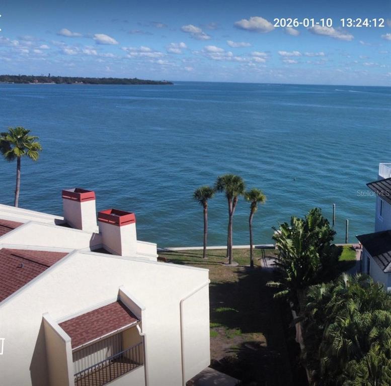 An aerial view shows a multi-story apartment building with red roofs and balconies — 7550 SUNSHINE SKYWAY LANE S UNIT P11, ST PETERSBURG, FL