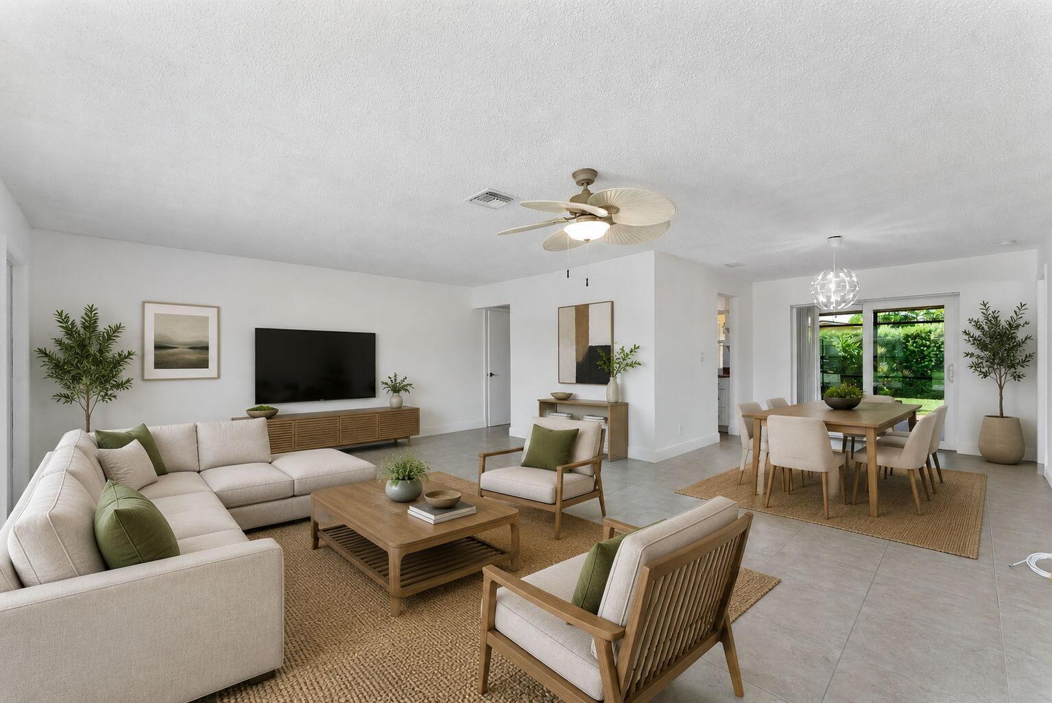 An open-concept living and dining room with neutral furniture, tile flooring, and a ceiling fan — 6396 Whispering Wind Way, Delray Beach FL 33484, DELRAY BEACH, FL