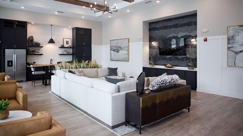 A modern living room features a large sectional sofa, dark cabinetry, and a television wall — 9500 GRANDTREE AVENUE UNIT C1, VENICE, FL