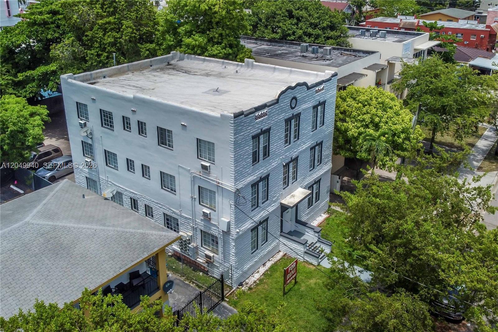 An aerial view shows a three-story white apartment building with a flat roof — 1563 SW 2nd St, Miami FL 33135, MIAMI, FL