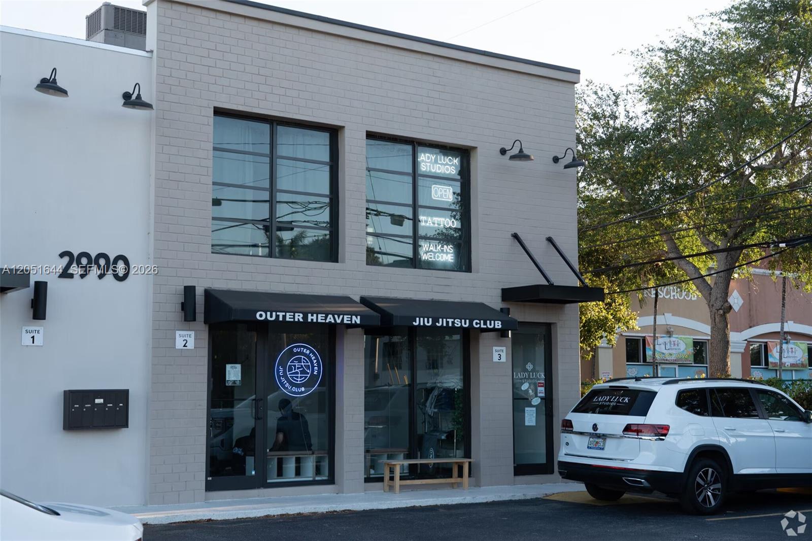 A two-story commercial building with a gray brick facade and black awnings over the entrances — 2990 Griffin Rd, Dania Beach FL 33312, DANIA BEACH, FL