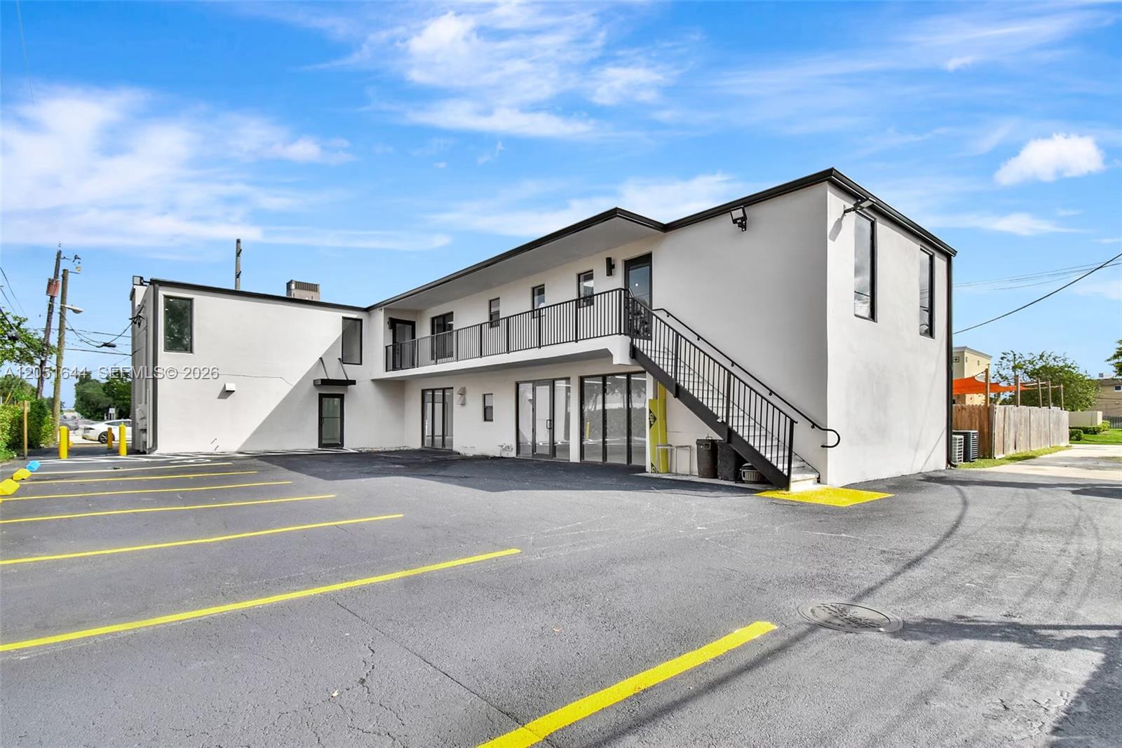 A two-story commercial building with a parking lot and an exterior staircase — 2990 Griffin Rd, Dania Beach FL 33312, DANIA BEACH, FL