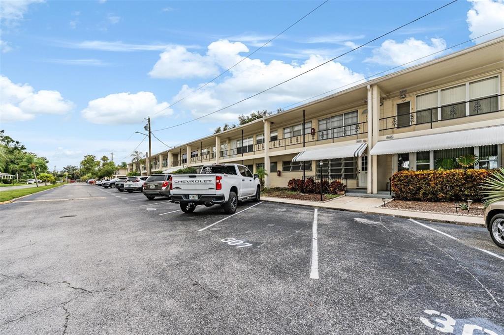 A white Chevrolet pickup truck is parked in front of a two-story apartment building — 5665 40TH AVENUE N UNIT 407, KENNETH CITY, FL