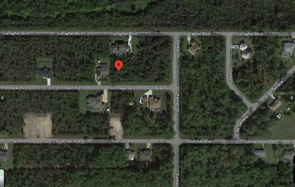 This is an aerial map view of a residential neighborhood with wooded lots and streets — 13220 FELDSPAR AVENUE, PORT CHARLOTTE, FL