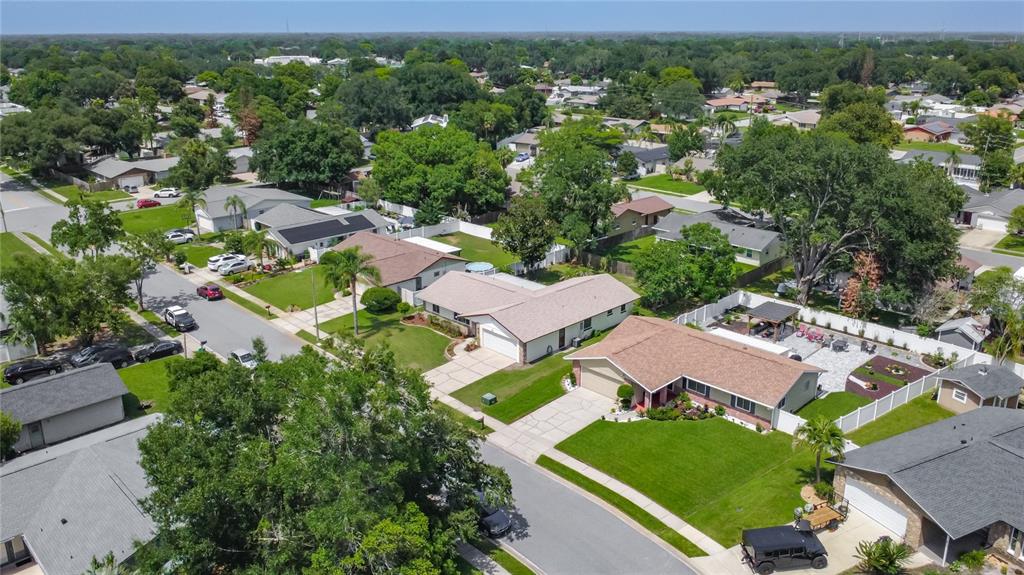 An aerial view shows suburban homes with driveways, green lawns, and mature trees — 5225 ALBERT DRIVE, WINTER PARK, FL