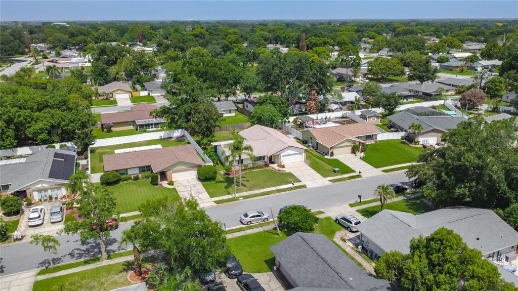 An aerial view shows several suburban houses with driveways, lawns, and trees on a street — 5225 ALBERT DRIVE, WINTER PARK, FL