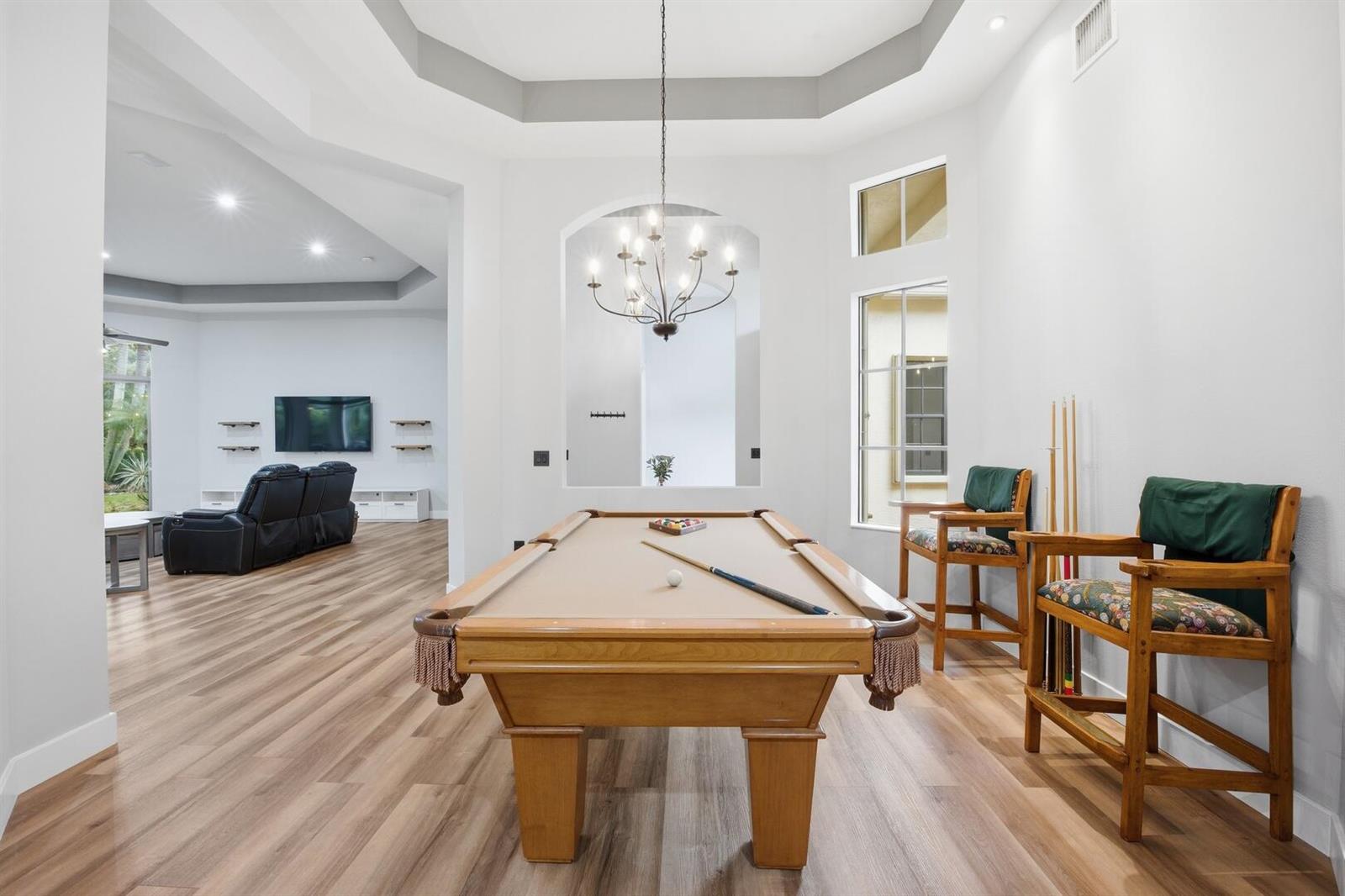 A game room features a pool table, two wooden chairs, and a view into a living area — 6983 Antinori Lane, Boynton Beach FL 33437, BOYNTON BEACH, FL