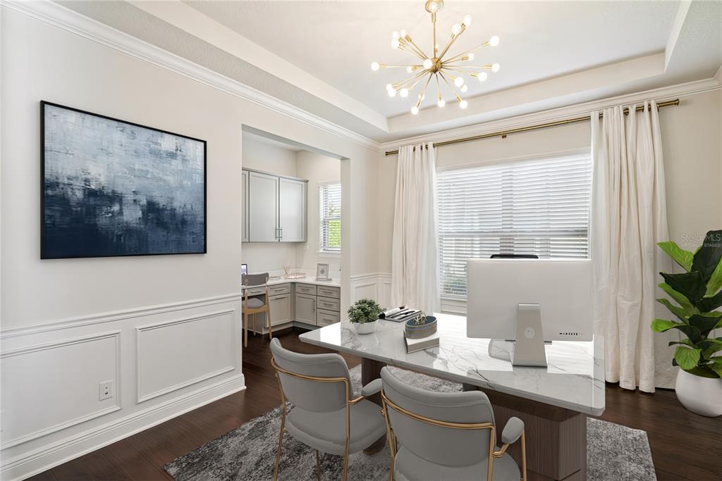 A home office features a marble desk, two chairs, a chandelier, and an adjacent workspace — 8591 ADALINA PLACE, ORLANDO, FL