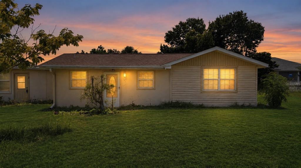 An empty swimming pool sits inside a large, screened-in patio with a white metal roof — 200 ORDUNA DRIVE, NORTH PORT, FL