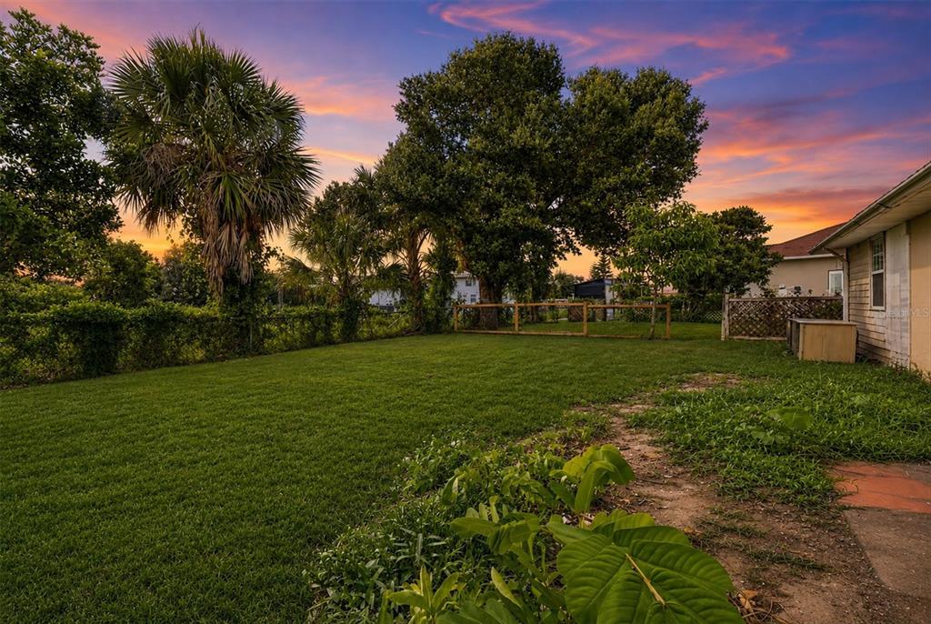 A single-story house with light-colored siding and a front lawn at sunset — 200 ORDUNA DRIVE, NORTH PORT, FL