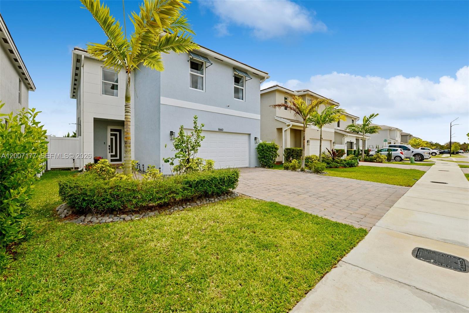 A two-story gray house with a two-car garage and a paved driveway — 1660 SE 6th St, Homestead FL 33033, HOMESTEAD, FL