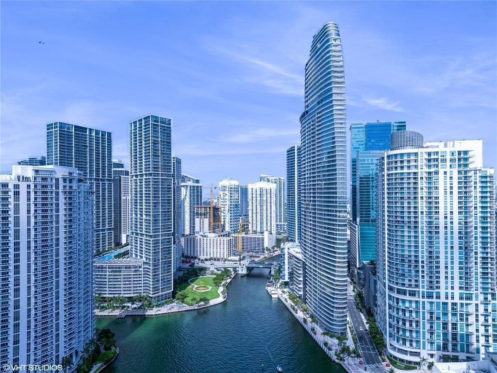 An aerial view of a canal surrounded by modern high-rise buildings in a city — 300 Biscayne Blvd Way # 2508, Miami FL 33131, MIAMI, FL