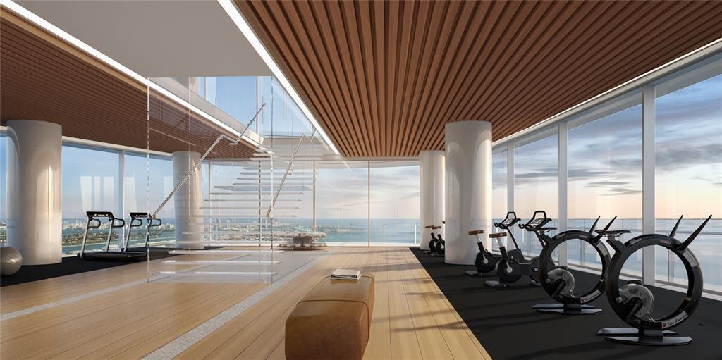 This rendering shows a modern gym with exercise bikes, a glass staircase, and floor-to-ceiling windows — 300 Biscayne Blvd Way # 2508, Miami FL 33131, MIAMI, FL