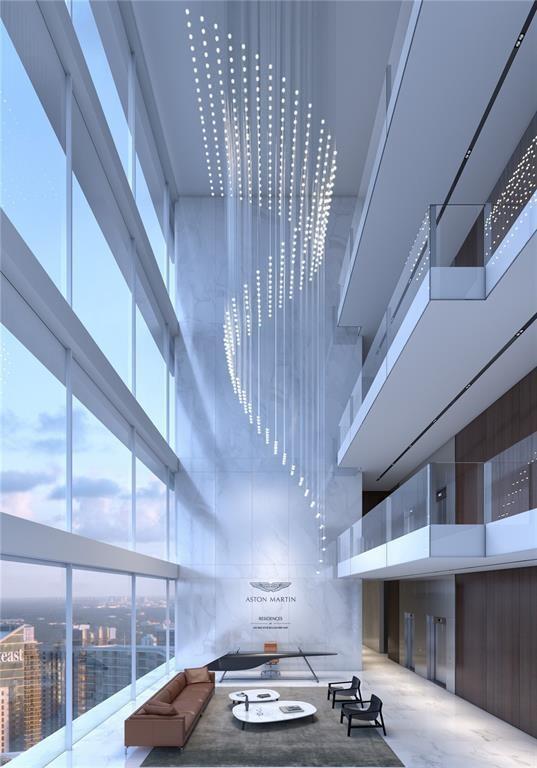 This rendering shows a modern, high-ceilinged lobby with a large spiral light fixture and marble walls — 300 Biscayne Blvd Way # 2508, Miami FL 33131, MIAMI, FL