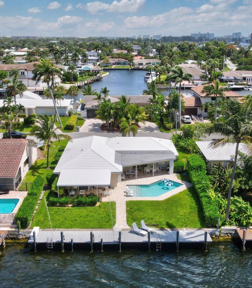 An aerial view of a waterfront house with a swimming pool, patio, and private dock — 2762 NE 3rd St, Pompano Beach FL 33062, POMPANO BEACH, FL