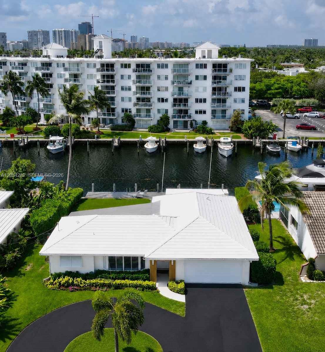 An aerial view shows a white single-story house with a canal and boat docks behind — 2762 NE 3rd St, Pompano Beach FL 33062, POMPANO BEACH, FL