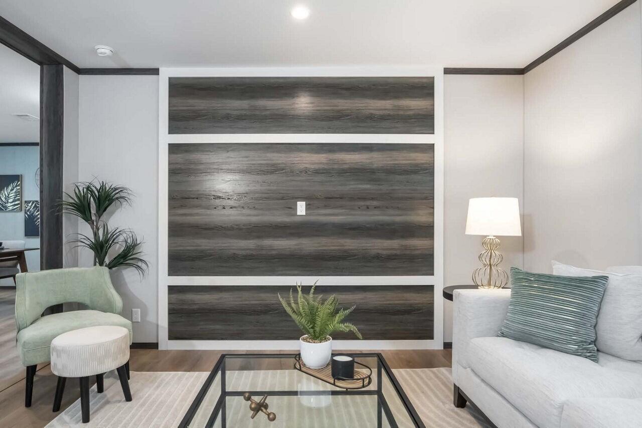 A living room features a wood-paneled accent wall, a light-colored sofa, and a green chair — 19520 NW 260th Street, Okeechobee FL 34972, OKEECHOBEE, FL