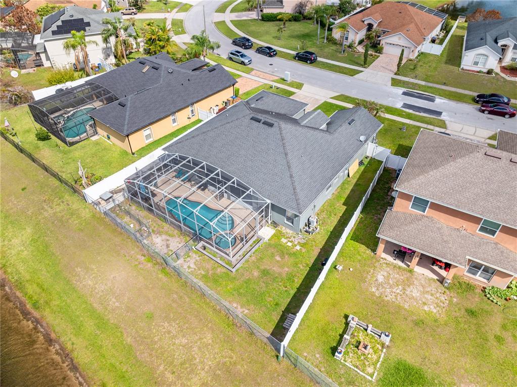 An aerial view shows a residential house with a screened-in pool and backyard — 442 TAMARIND PARKE LANE, KISSIMMEE, FL