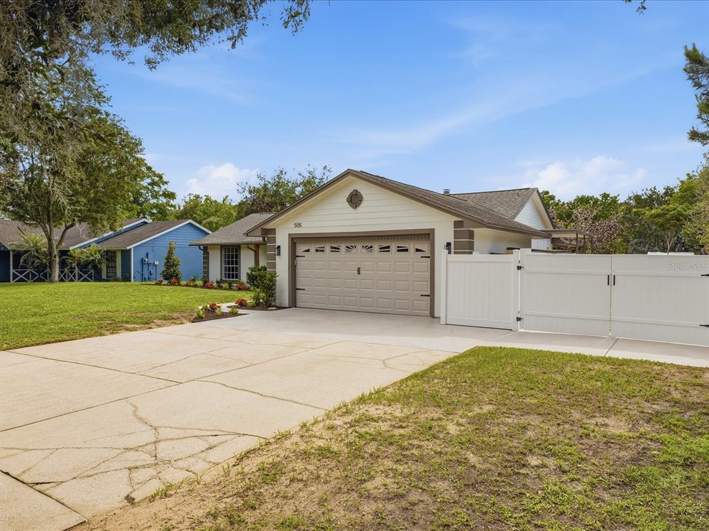An aerial view shows a house with a pool enclosure on a fenced residential lot — 505 LAKE CHARM DRIVE, OVIEDO, FL