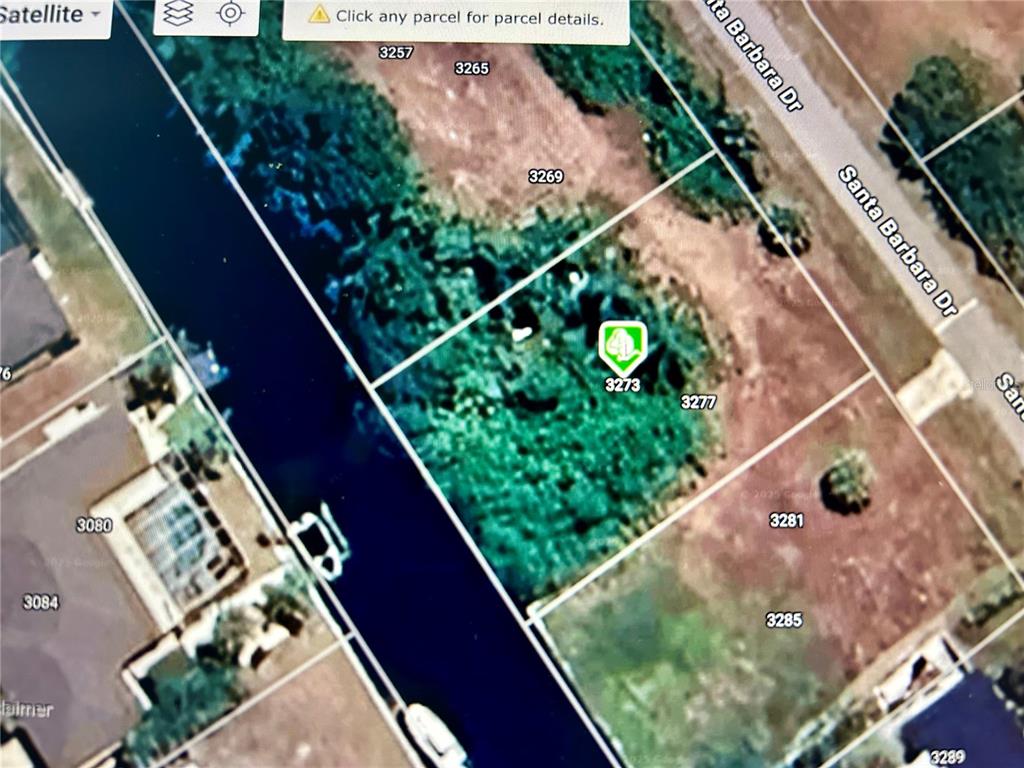 This is a satellite map view showing a vacant residential lot along a canal — 3273 SANTA BARBARA DRIVE, PUNTA GORDA, FL