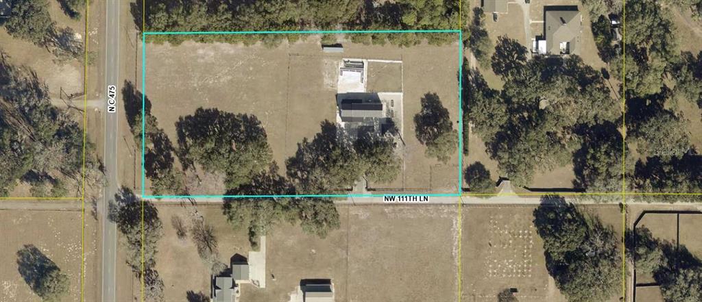 This aerial map shows a rectangular property with a house and outbuildings on a lot — 904 NW 111TH LANE, OXFORD, FL