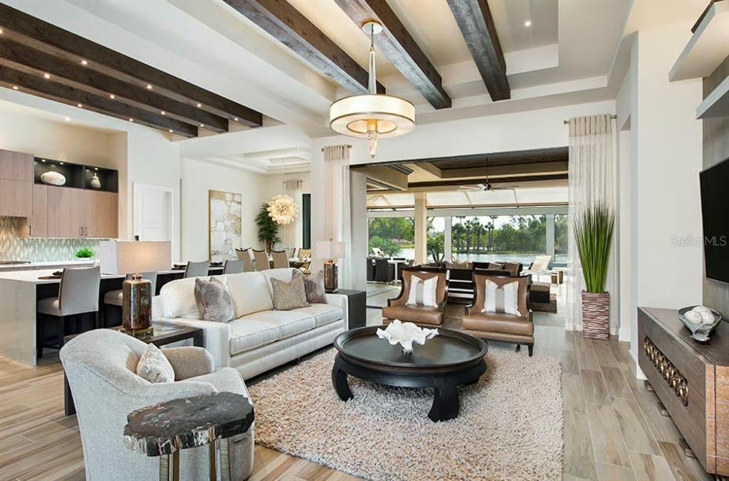 A living room features exposed ceiling beams, a large chandelier, and an open outdoor view — 185 S RIVERWALK DRIVE, PALM COAST, FL