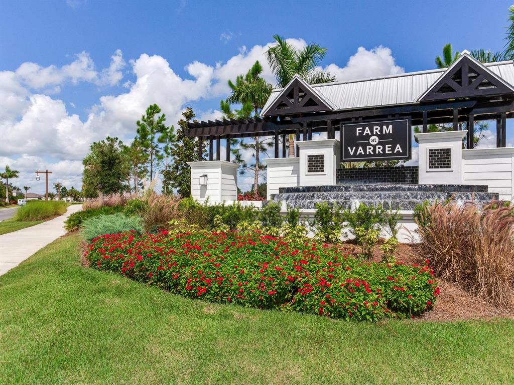 A landscaped entrance sign for Farm at Varrea features a water fountain and pergola structure — 3723 STORMY THISTLE PLACE, PLANT CITY, FL