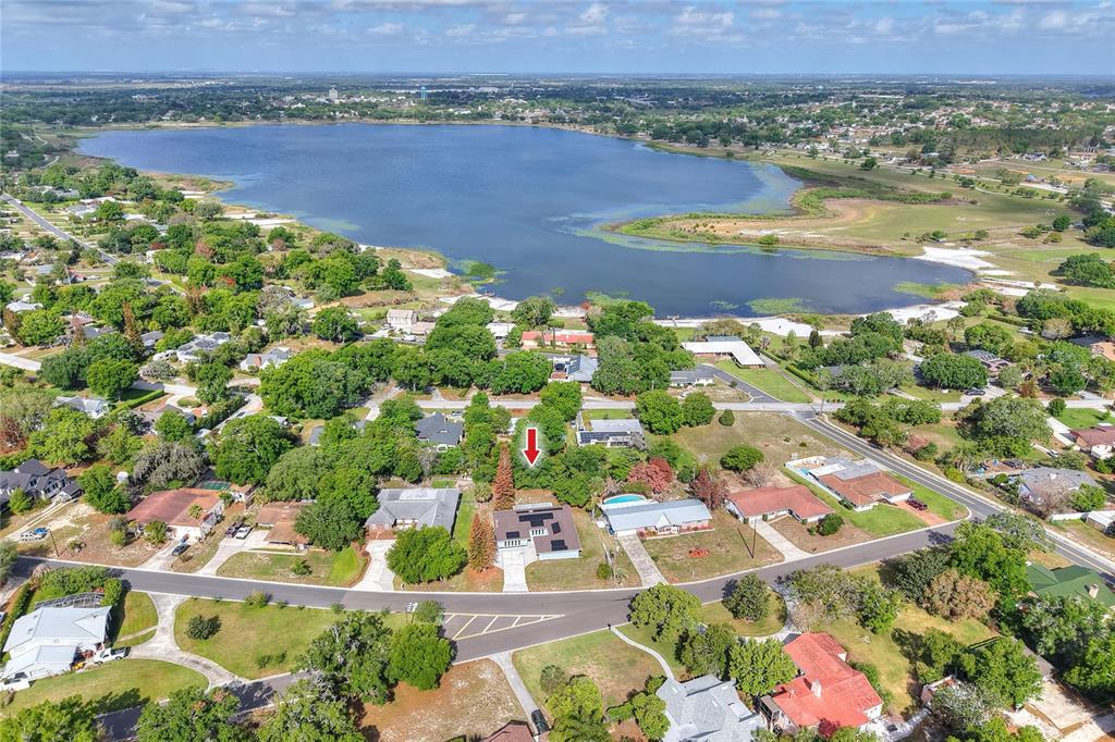 An aerial view shows a residential neighborhood with a lake in the background — 1147 CIRCLE DRIVE, LAKE WALES, FL