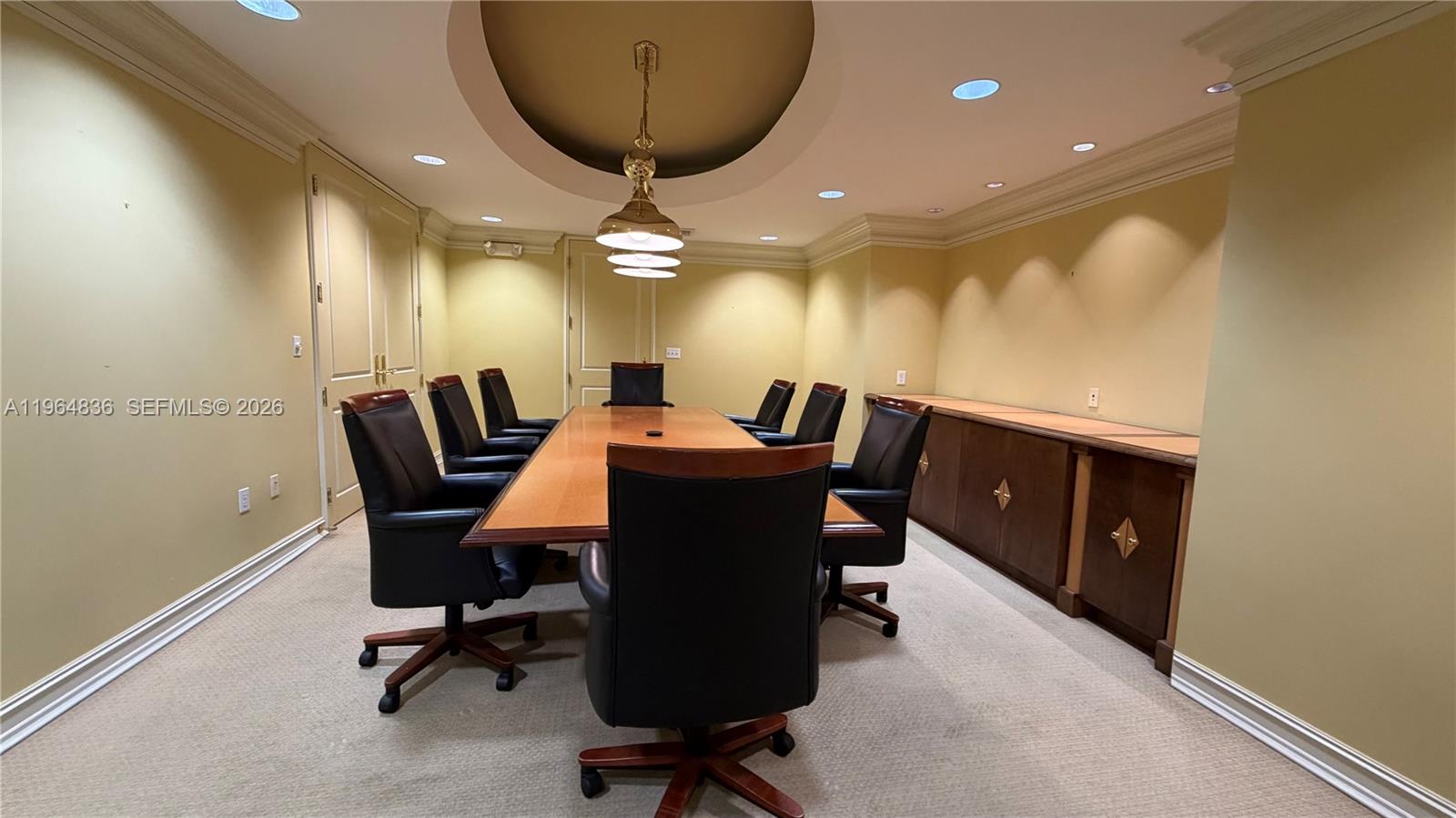 A conference room features a long wooden table, black leather chairs, and recessed ceiling lighting — 2435 Hollywood Blvd, Hollywood FL 33020, HOLLYWOOD, FL