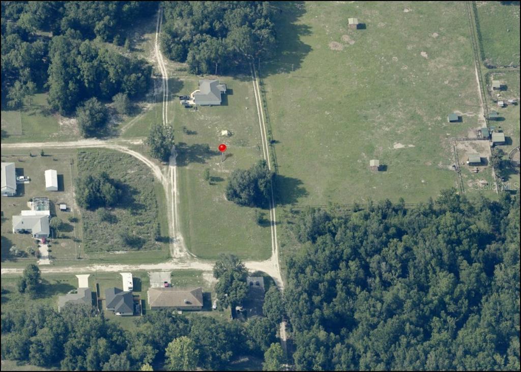 An aerial view shows a vacant lot with a red marker surrounded by rural residential properties — Lot 3 SW 130TH COURT, DUNNELLON, FL