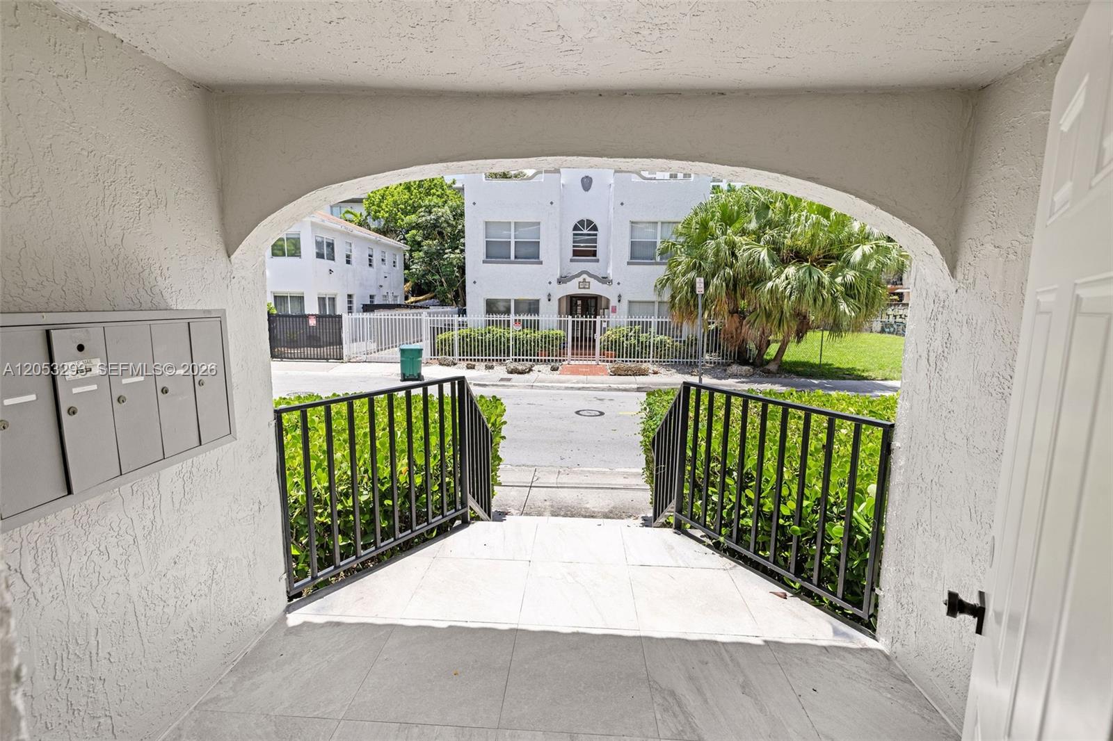 A view from a covered entryway looking out toward a street and apartment building — 417 NE 26th St # 5, Miami FL 33137, MIAMI, FL