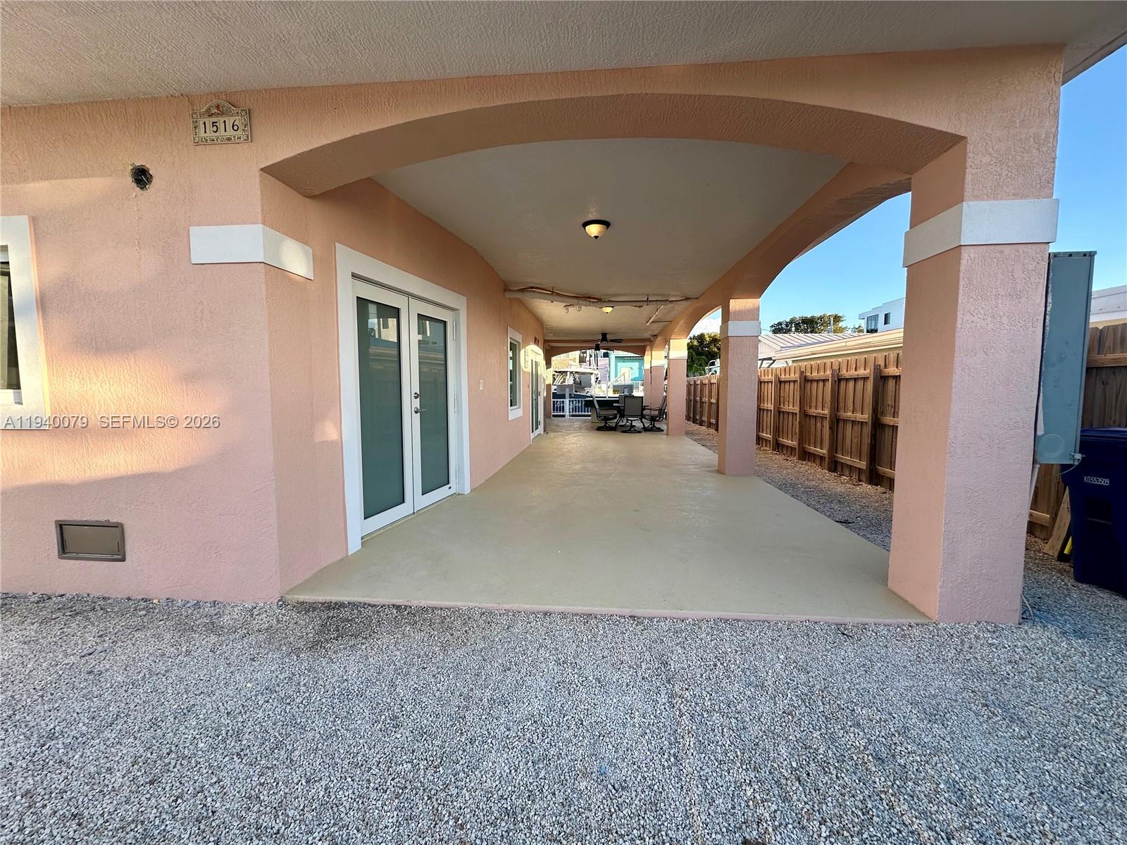 A three-story peach-colored house stands at the end of a gravel driveway — 1516 Aqueduct Ln # 1, Key Largo FL 33037, KEY LARGO, FL