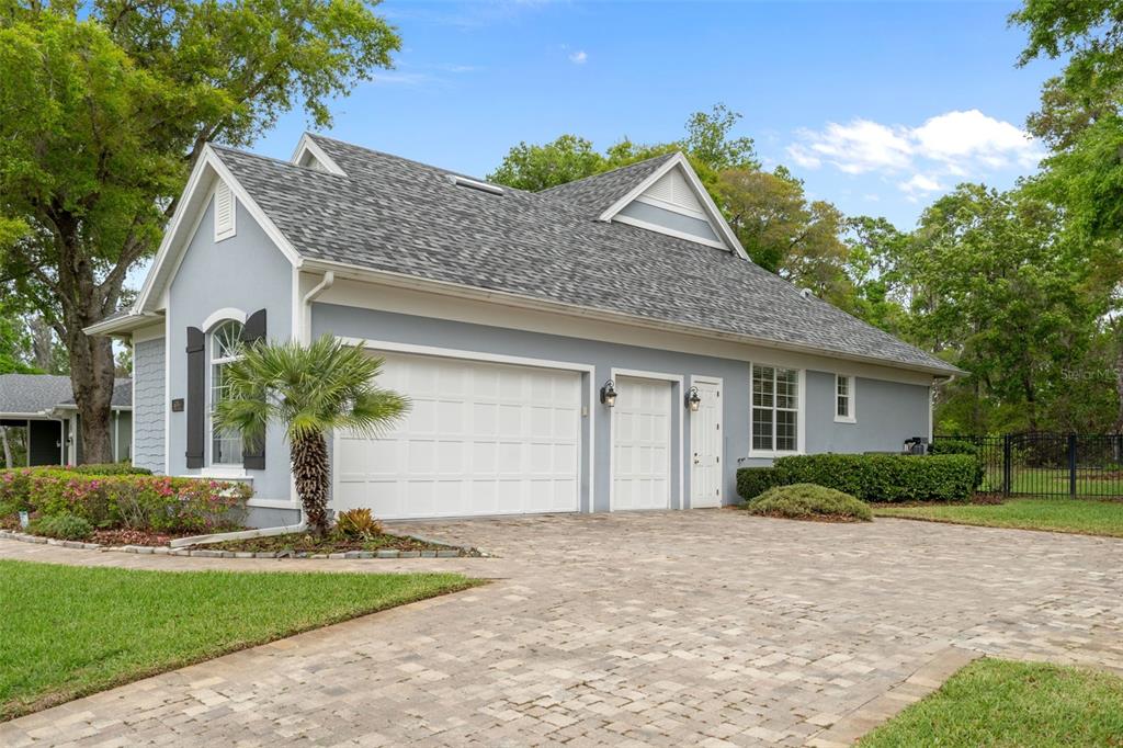 A light blue house with a gray shingled roof and a paved driveway — 6096 DUSK ROSE LANE, BROOKSVILLE, FL