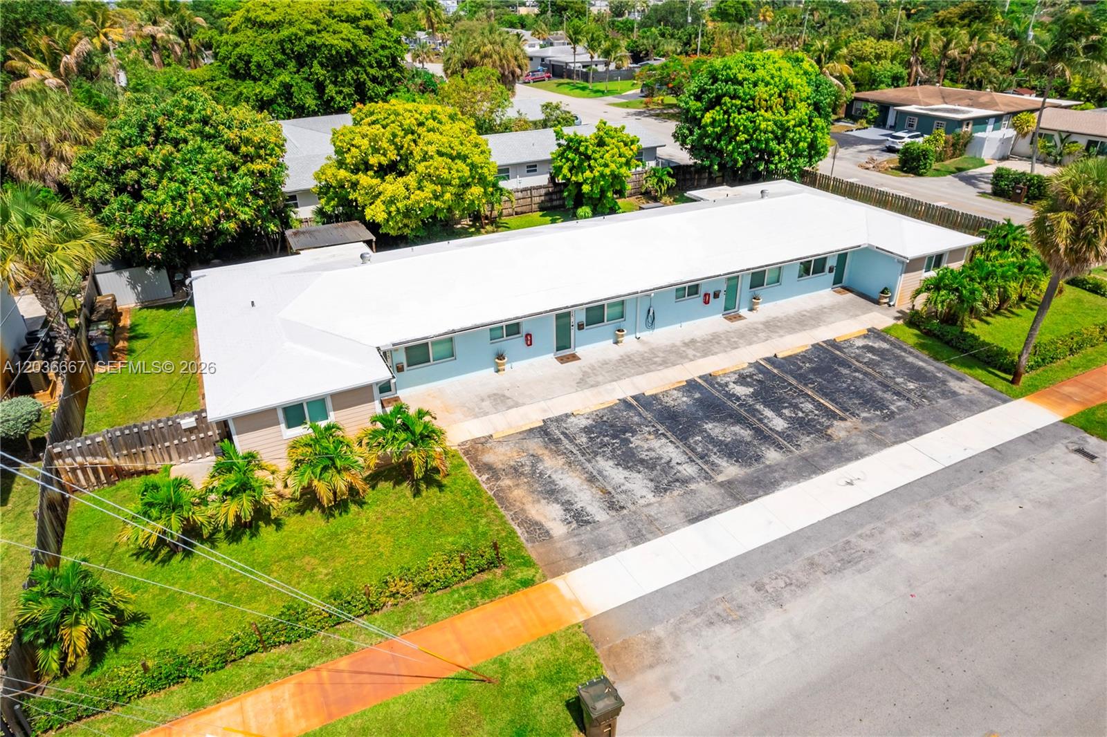 An aerial view shows a single-story multi-unit building with a white roof and parking spaces — 4008 NW 5th Ave, Oakland Park FL 33309, OAKLAND PARK, FL