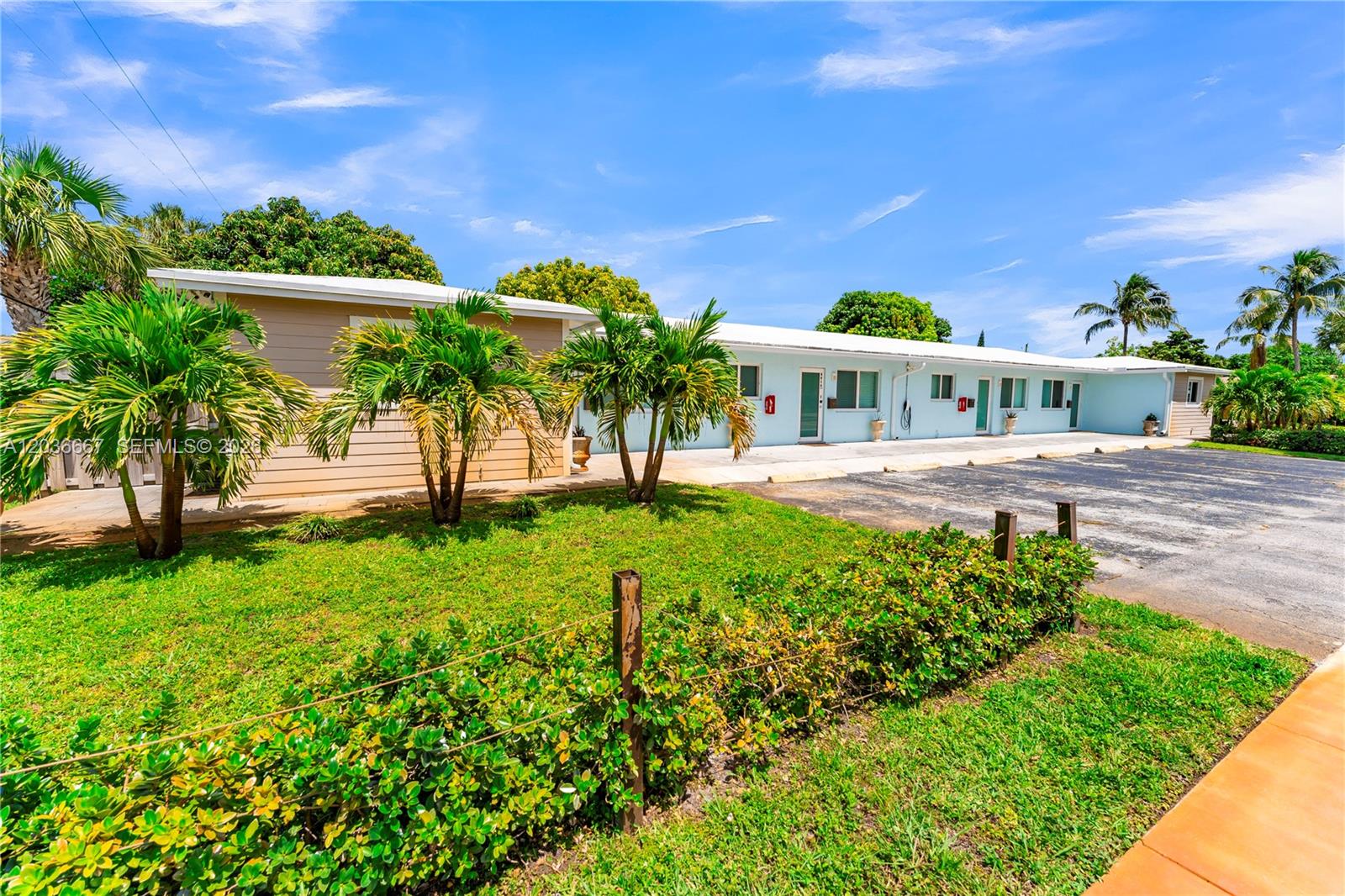 A single-story, light-blue apartment building with a parking lot and palm trees in front — 4008 NW 5th Ave, Oakland Park FL 33309, OAKLAND PARK, FL