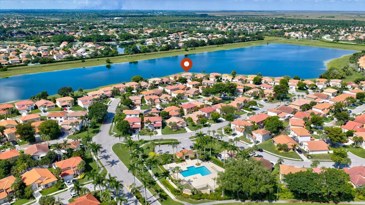 An aerial view of a suburban neighborhood featuring a large lake and a community pool — 10712 Oak Lake Way, Boca Raton FL 33498, BOCA RATON, FL