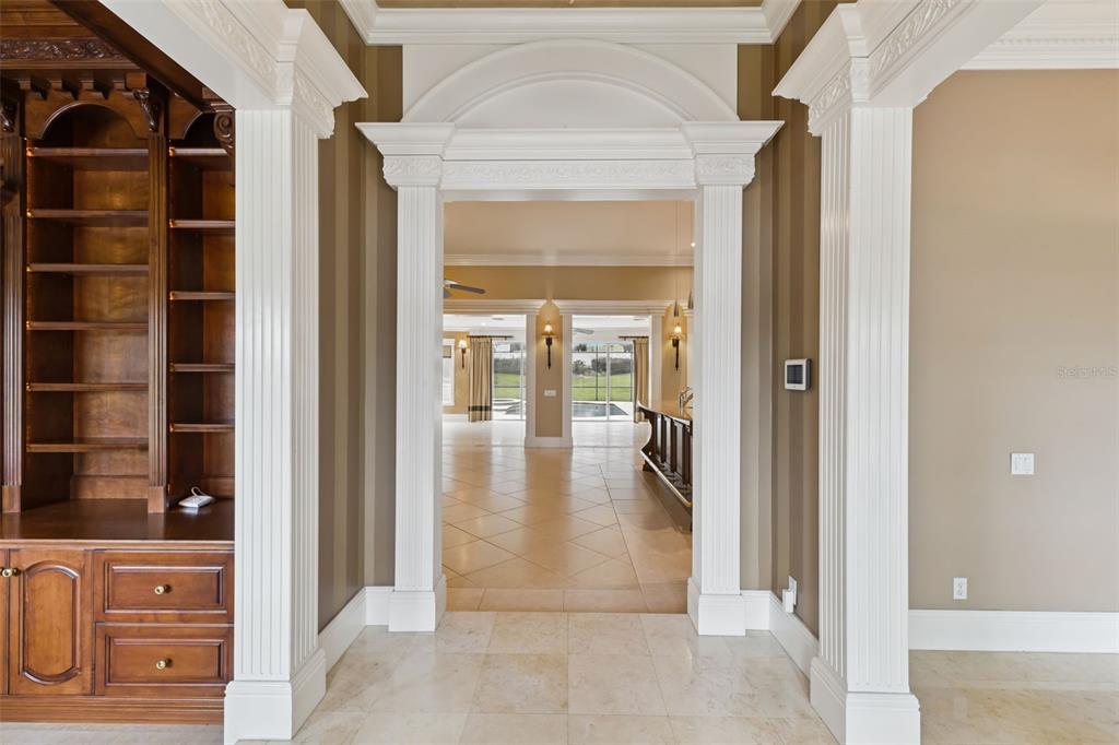 A white house with a red roof and a detached garage sits on a lawn — 15000 THOROUGHBRED LN, MONTVERDE, FL