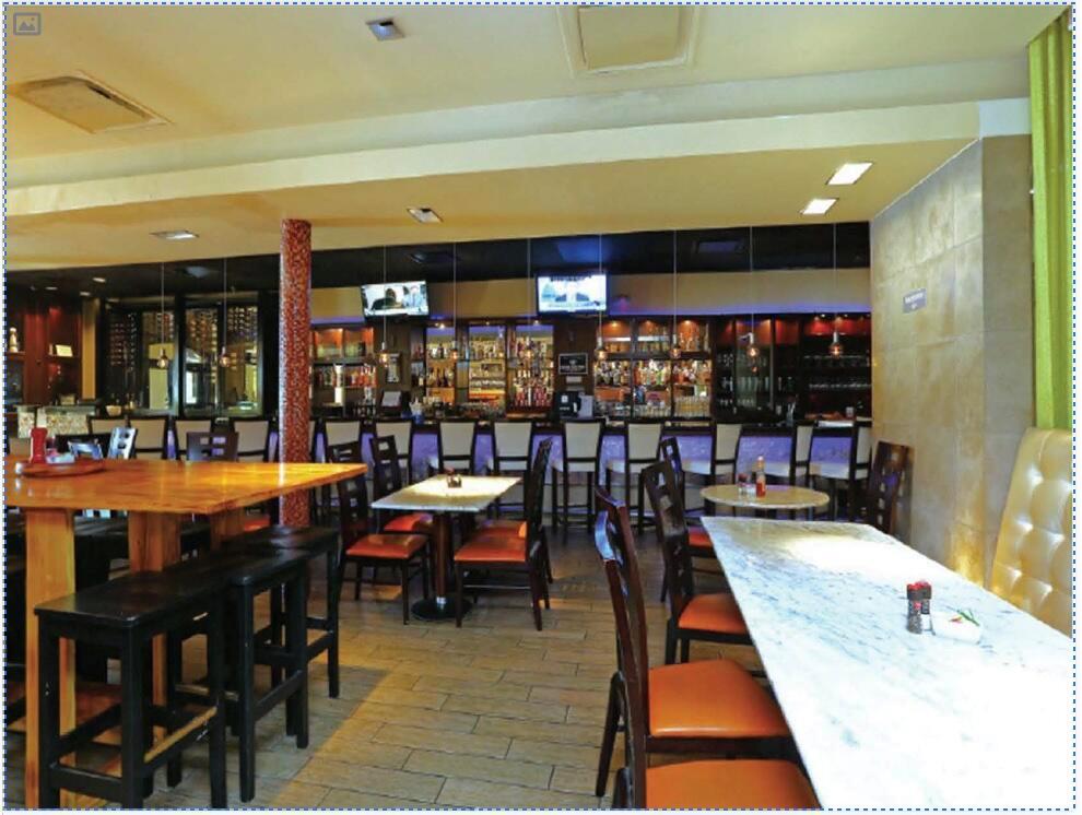 A restaurant interior features a long bar, wooden and marble tables, and orange chairs — 1450 N Federal Highway, Boca Raton FL 33432, BOCA RATON, FL
