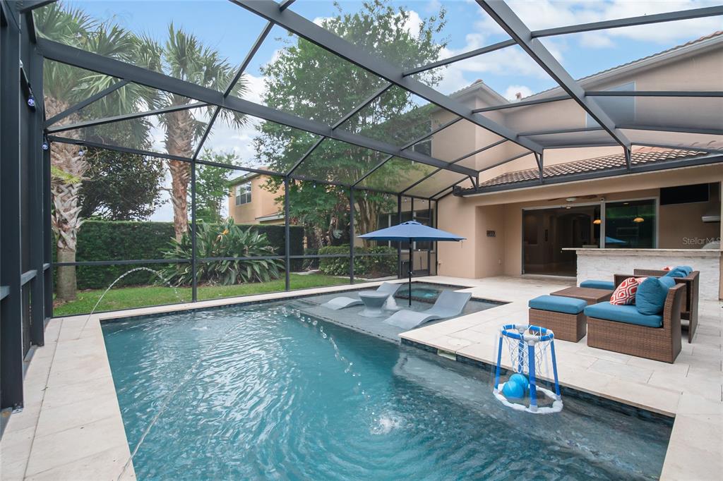 A screened-in patio features a swimming pool with a tanning ledge and outdoor seating — 11763 AURELIO LN, ORLANDO, FL