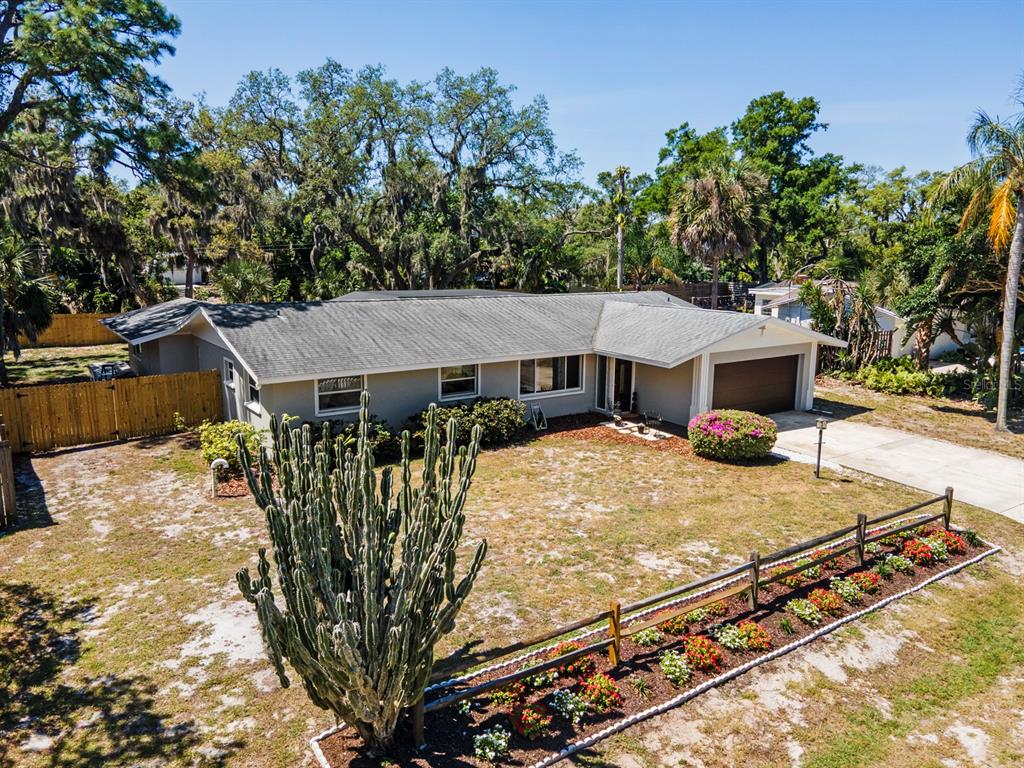An aerial view of a single-story house with a cactus, flower bed, and wooden fence — 2352 PALM TERRACE, SARASOTA, FL